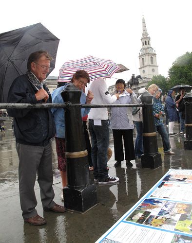 '民众冒雨了解法轮功真相'