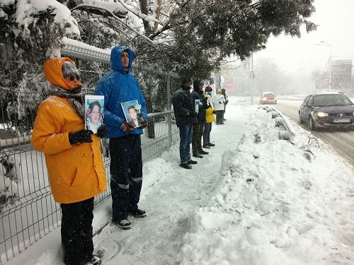 图2-4：学员们手持被迫害致死的法轮功学员照片，在中使馆前和平抗议